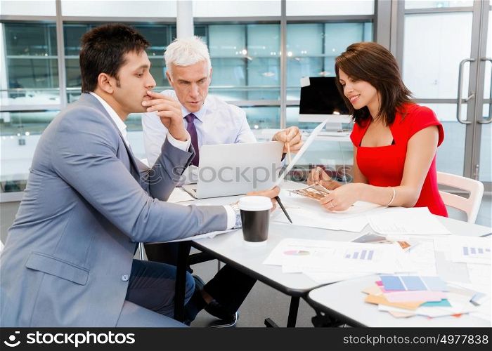 Businesspeople in office having discussion. Working as a team
