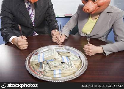 Businesspeople in pig masks sat in front of money