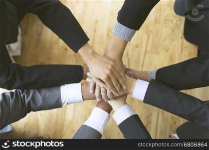businesspeople in suit put their hand stack on top of each other, colleagues pile of hand - teamwork, unity, success collaboration leader concept