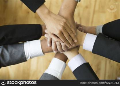 businesspeople in suit put their hand stack on top of each other, colleagues pile of hand - teamwork, unity, success collaboration leader concept