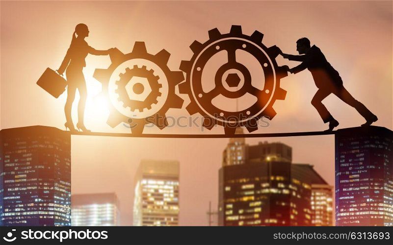 Businesspeople in teamwork example with cogwheels