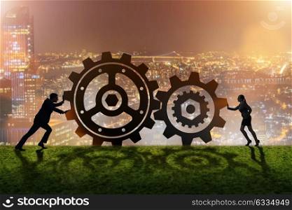 Businesspeople in teamwork example with cogwheels