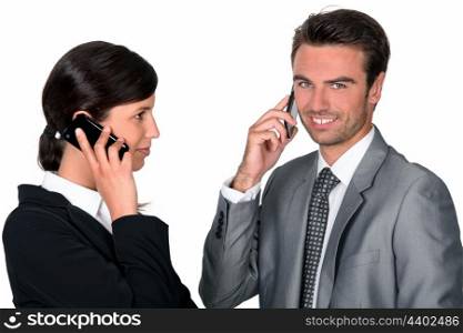Businesspeople making simultaneous calls