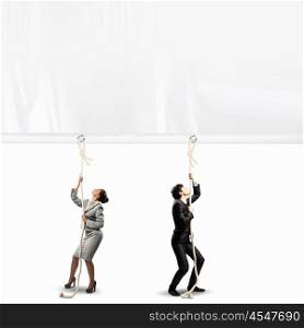 Businesspeople pulling banner. Image of two businesspeople pulling blank banner