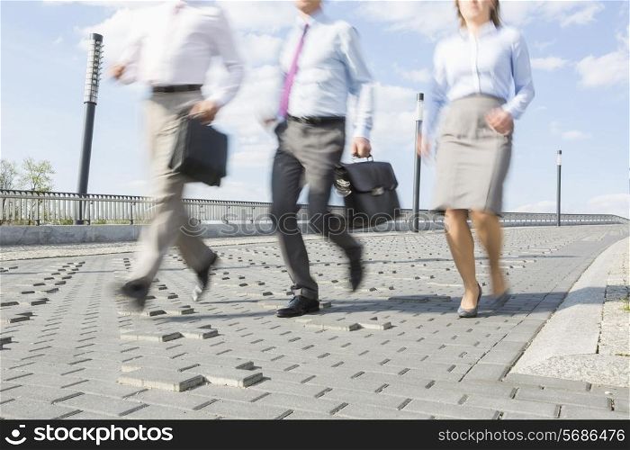 Businesspeople running on bridge