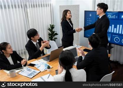 Businesspeople shake hand after successful agreement or meeting. Office worker colleague handshake with business team leader manager for strong teamwork in office to promote harmony and unity concept.. Employees shake hand for symbol of harmony after successful business meeting.