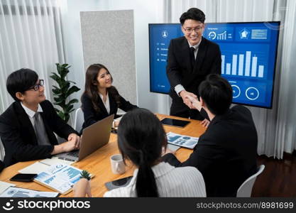 Businesspeople shake hand after successful agreement or meeting. Office worker colleague handshake with business team leader manager for strong teamwork in office to promote harmony and unity concept.. Employees shake hand for symbol of harmony after successful business meeting.