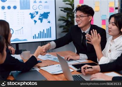 Businesspeople shake hand after successful agreement or meeting. Office worker colleague handshake with business team leader manager for strong teamwork in office to promote harmony and unity concept.. Employees shake hand for symbol of harmony after successful business meeting.