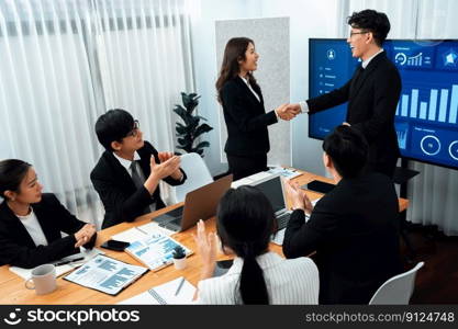 Businesspeople shake hand after successful agreement or meeting. Office worker colleague handshake with business team leader manager for strong teamwork in office to promote harmony and unity concept.. Employees shake hand for symbol of harmony after successful business meeting.