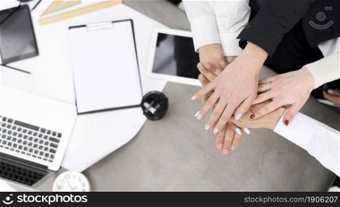 businesspeople stacking each other s hand desk. High resolution photo. businesspeople stacking each other s hand desk. High quality photo