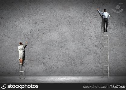 businesspeople standing on ladder drawing diagrams and graphs on wall
