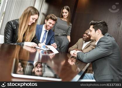 Businesspeople, teamwork. Group of multiethnic busy people working in an office