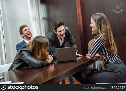 Businesspeople, teamwork. Group of multiethnic people laughing in an informal meeting in an office
