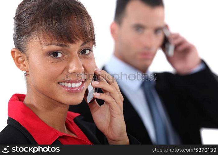 Businesspeople using cellphones