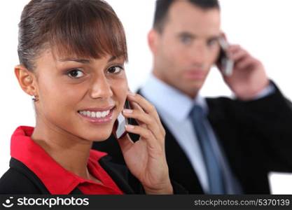 Businesspeople using cellphones