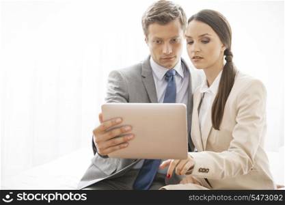 Businesspeople using digital tablet in hotel