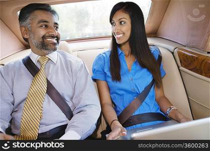 Businesspeople Using Laptop in Car
