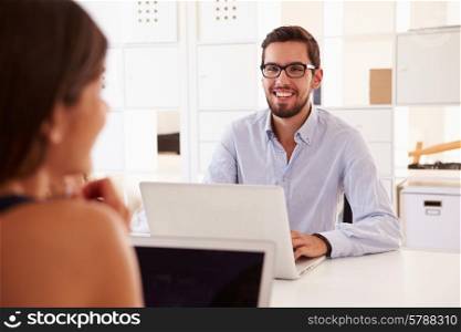 Businesspeople Using Laptop In Office Of Start Up Business