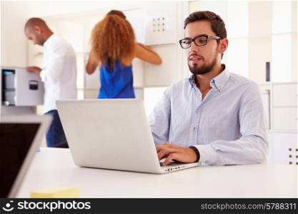 Businesspeople Using Laptop In Office Of Start Up Business