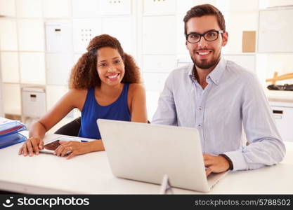 Businesspeople Using Laptop In Office Of Start Up Business