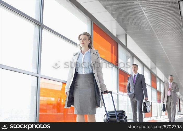 Businesspeople walking on train platform