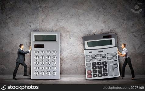 Businesspeople with big calculators