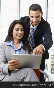 Businesspeople With Digital Tablet During Informal Meeting