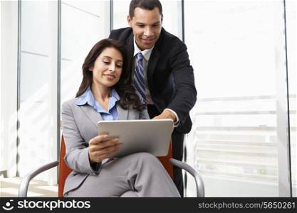 Businesspeople With Digital Tablet During Informal Meeting