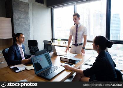 Businesspeople with leader discussing together in conference room during meeting at office.