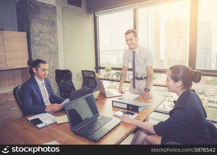 Businesspeople with leader discussing together in conference room during meeting at office.