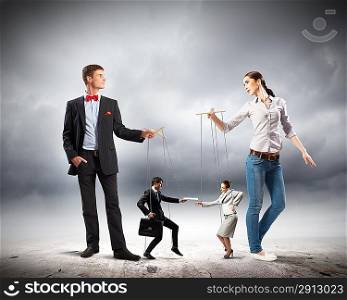 Businesspeople with marionettes