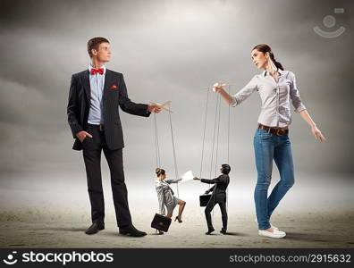 Businesspeople with marionettes