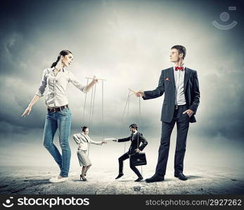 Businesspeople with marionettes