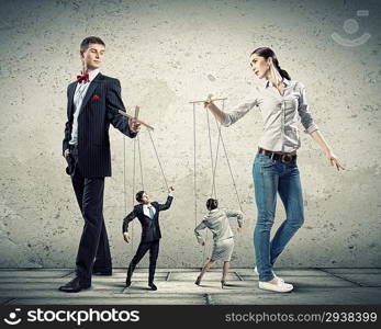 Businesspeople with marionettes