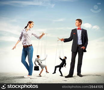 Businesspeople with marionettes