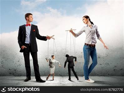 Businesspeople with marionettes