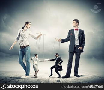 Businesspeople with marionettes. Image of man and woman with marionette puppets