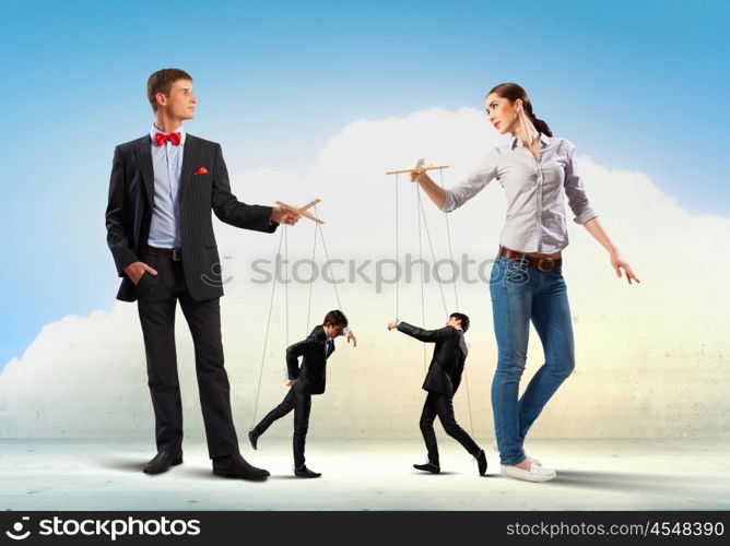 Businesspeople with marionettes. Image of man and woman with marionette puppets