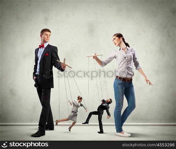 Businesspeople with marionettes. Image of man and woman with marionette puppets