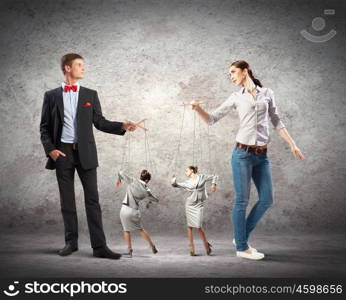 Businesspeople with marionettes. Image of man and woman with marionette puppets