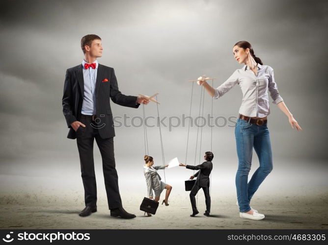 Businesspeople with marionettes. Image of man and woman with marionette puppets