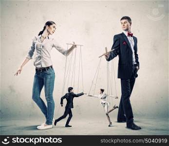 Businesspeople with marionettes. Image of man and woman with marionette puppets