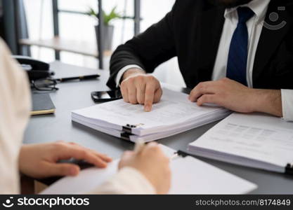 Businesspeople working in the office on official corporate papers, office workers reviewing stack of financial documents and working on business report. Equilibrium. Businesspeople working in the office on official corporate papers. Equilibrium