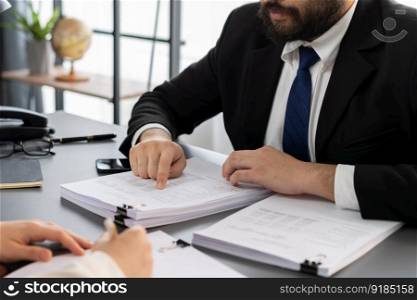 Businesspeople working in the office on official corporate papers, office workers reviewing stack of financial documents and working on business report. Equilibrium. Businesspeople working in the office on official corporate papers. Equilibrium