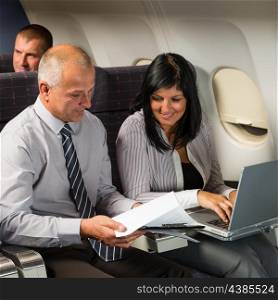 Businesspeople working on computer during flight airplane cabin passenger travel