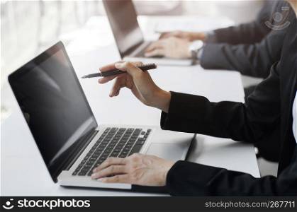 businesspeople working, using computer laptop, group discussing solution