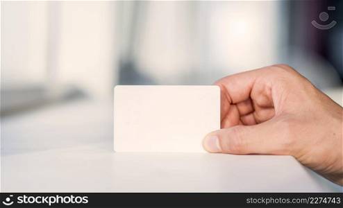 businessperson s hand holding blank white card