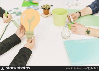 businessperson s hand holding light bulb icon