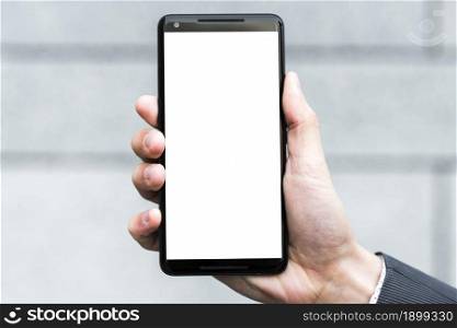 businessperson s hand showing white display screen smartphone against blurred backdrop. Resolution and high quality beautiful photo. businessperson s hand showing white display screen smartphone against blurred backdrop. High quality beautiful photo concept