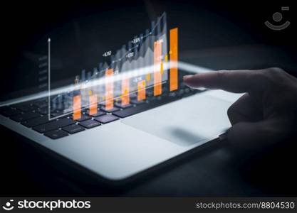 Businessperson using laptop computer with chart. business investment and financial concept of growth economic. Investor data analysis for planning in strategy of stock market fund.